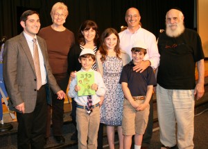 Caleb Peck (holding siddur) and family with Rabbi Jeffery Arnowitz. Caleb Peck (holding siddur) and family with Rabbi Jeffery Arnowitz.