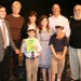 Caleb Peck (holding siddur) and family with Rabbi Jeffery Arnowitz. Elijah Arnowitz