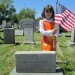 Zipporah Goldberg placing flags at the graves of Jewish Veterans at the B’nai Israel Cemetery.