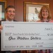 Philip Rovner and Shelby Tudor from the Tidewater Jewish Foundation graciously accept the Steins’ donation.