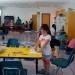 Post Camp JCC students enjoy the new Kids Connection space as staff members move in the last pieces of furniture and books and set up the computers.
