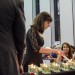 Elizabeth Hughes, granddaughter of four survivors, lights a candle in memory of children who perished.
