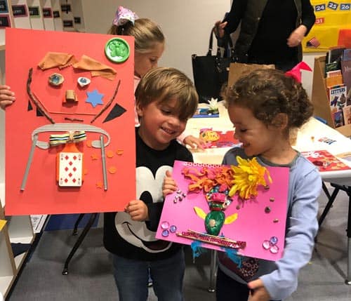 Jack Trompeter and Arbel Horev with their portraits made at Super Sunday’s Family Workshop.