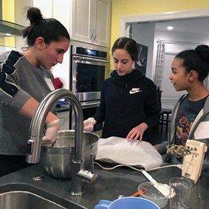 Shayda Rahimzadeh, Lior Lehmann, and Ellie Debb mix cookies. Shayda Rahimzadeh, Lior Lehmann, and Ellie Debb mix cookies.