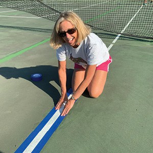 Stephanie Calliot helps prepare courts for pickleball. Stephanie Calliot helps prepare courts for pickleball.